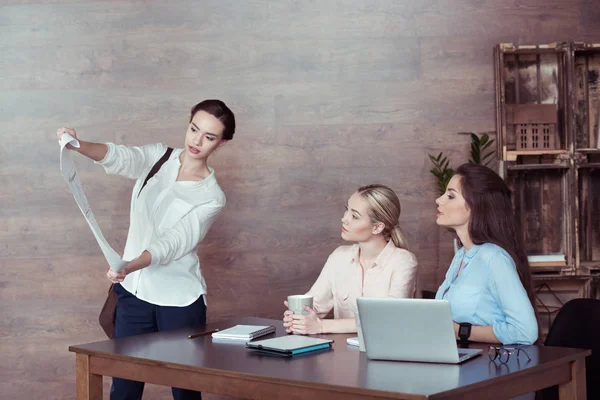 Architect showing blueprint to colleagues — Stock Photo