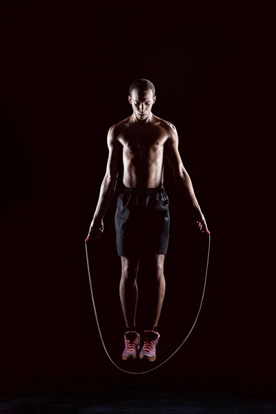 Sporty man with skipping rope — Stock Photo