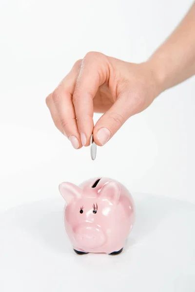 Putting coin in piggy bank — Stock Photo