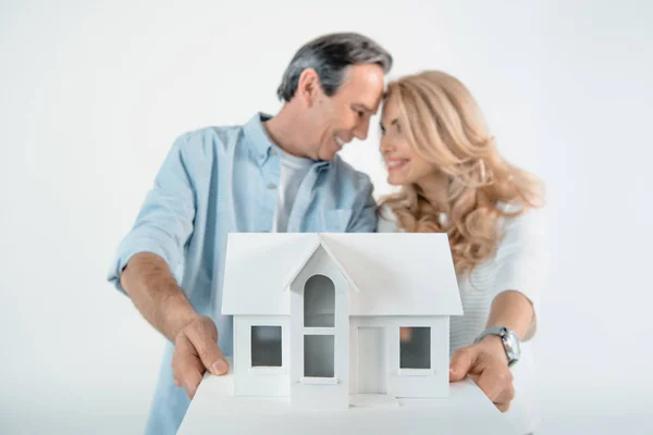 Couple with house model — Stock Photo