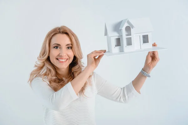 Woman with house model — Stock Photo
