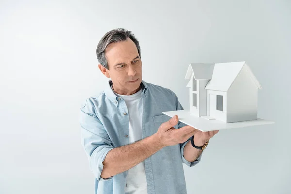 Man with house model — Stock Photo