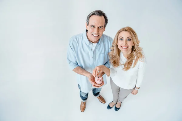 Mature couple with piggy bank — Stock Photo