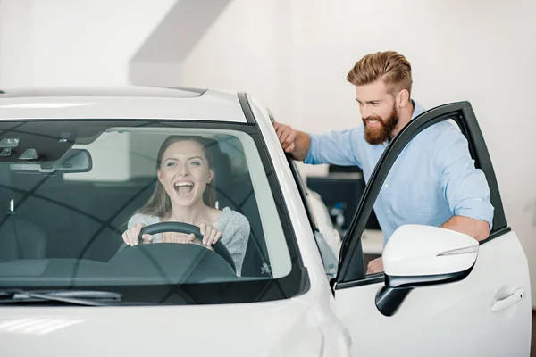 Frau sitzt in neuem Auto — Stockfoto