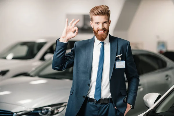 Salesman in dealership salon — Stock Photo