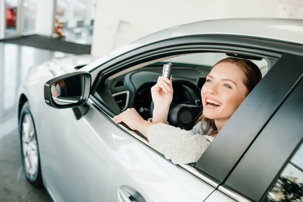 Woman sitting in new car — Stock Photo