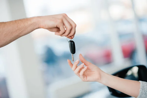 Customer and salesman with car key — Stock Photo