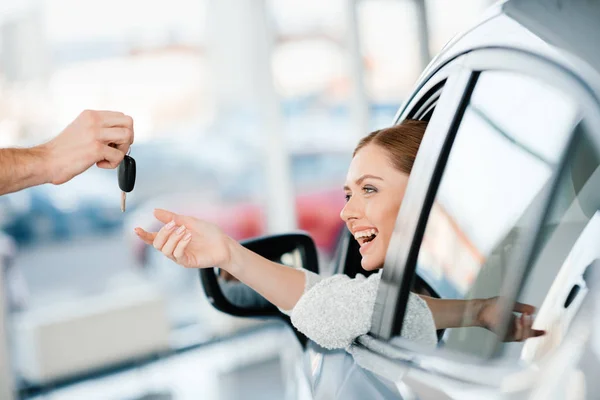 Woman sitting in new car — Stock Photo