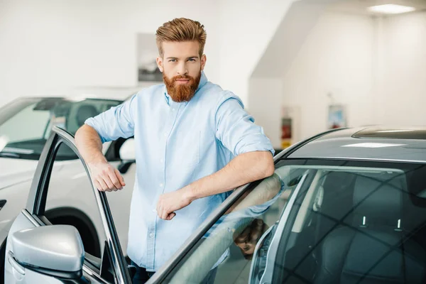 Young man with new car — Stock Photo