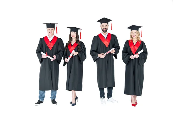 Happy students with diplomas — Stock Photo