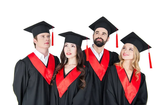 Happy students in mortarboards — Stock Photo