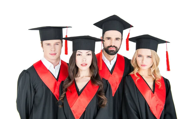 Happy students in mortarboards — Stock Photo