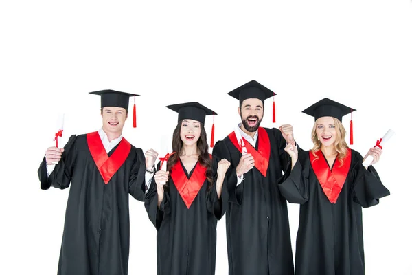 Happy students with diplomas — Stock Photo