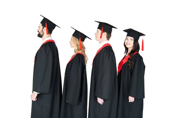 Happy students in mortarboards — Stock Photo