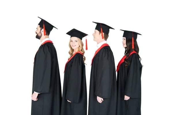 Happy students in mortarboards — Stock Photo