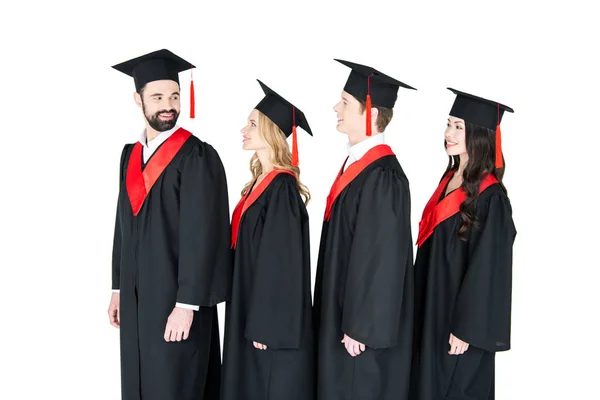 Happy students in mortarboards — Stock Photo