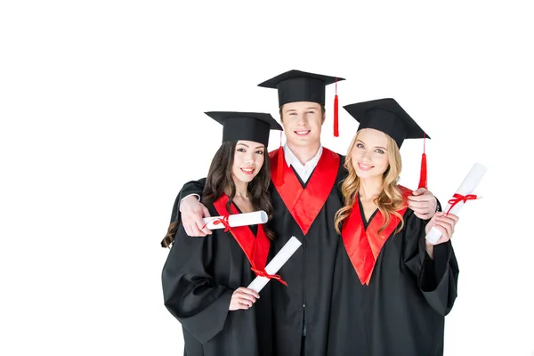 Studenti felici con diplomi — Foto stock