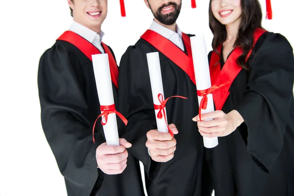 Happy students with diplomas — Stock Photo