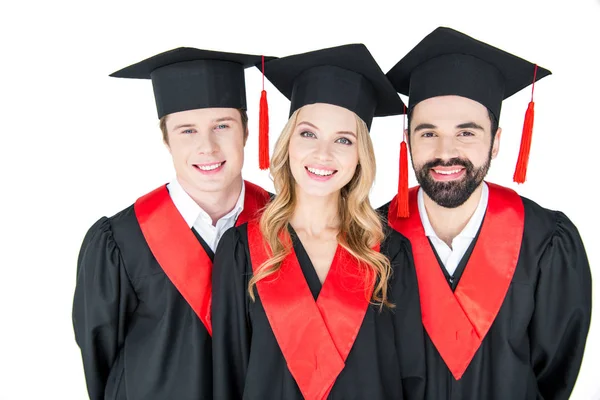 Happy students in mortarboards — Stock Photo