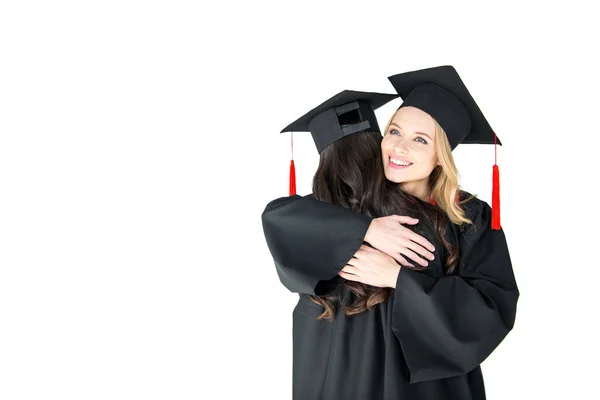 Happy young women in mortarboards — Stock Photo