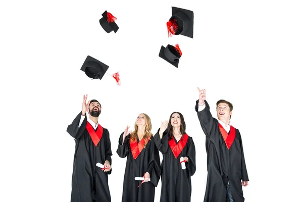 Students throwing graduation caps — Stock Photo