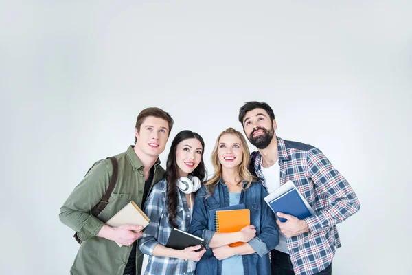 Quatro estudantes com livros — Fotografia de Stock