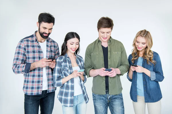 Friends using smartphones — Stock Photo