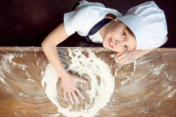 Child making pizza dough — Stock Photo