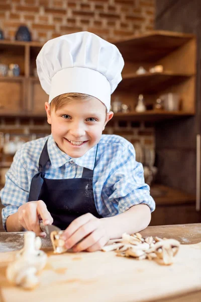 Boy cutting mushrooms — Stock Photo