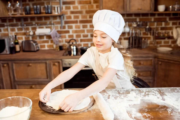 Girl making pizza dough — Stock Photo