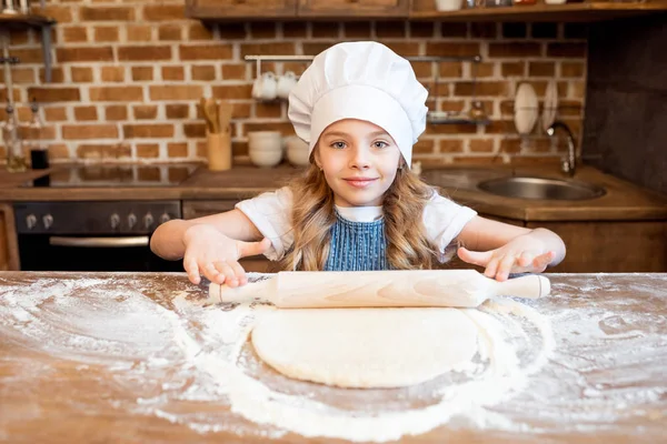 Girl rolling out gough — Stock Photo