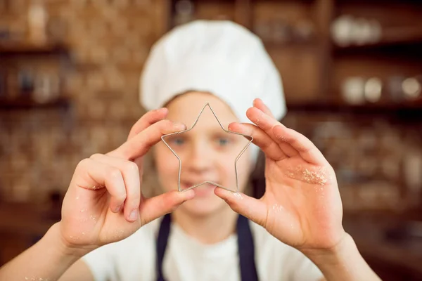 Boy holding cookie cutter — Stock Photo