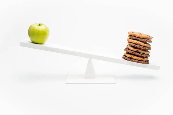 Apple and cookies on swing — Stock Photo