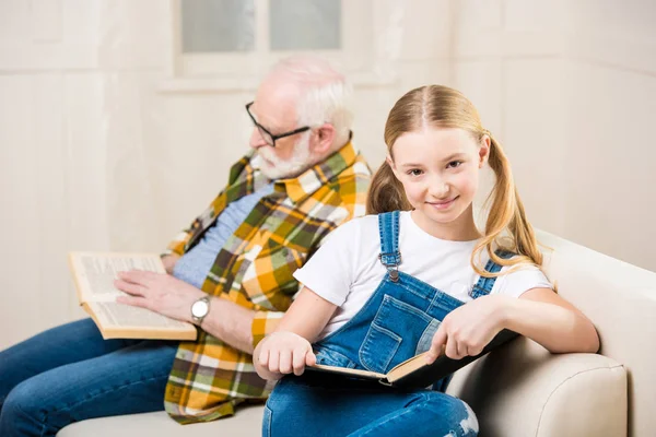 Grandfather with girl reading books — Stock Photo