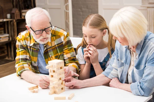 Family playing jenga game — Stock Photo