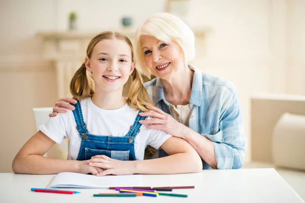 Girl with grandmother drawing — Stock Photo