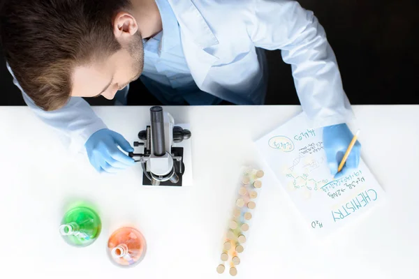 Scientist working with microscope — Stock Photo