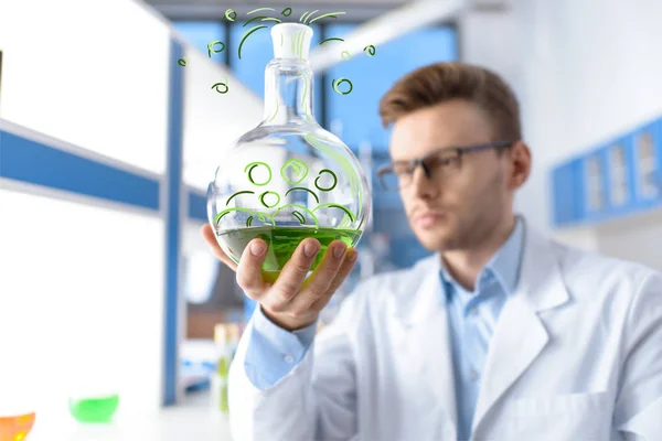 Chemist holding flask — Stock Photo