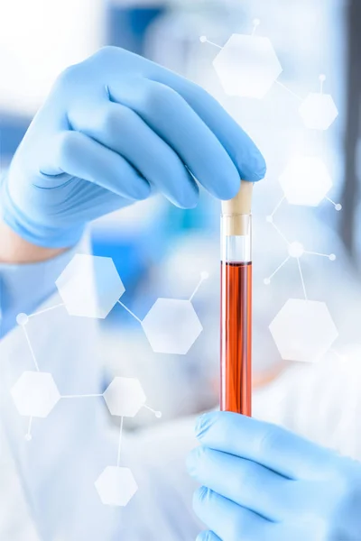 Chemist with test tube in hands — Stock Photo