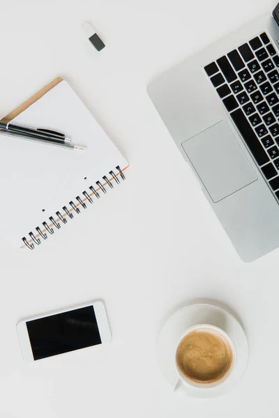 Laptop with office supplies and smartphone — Stock Photo