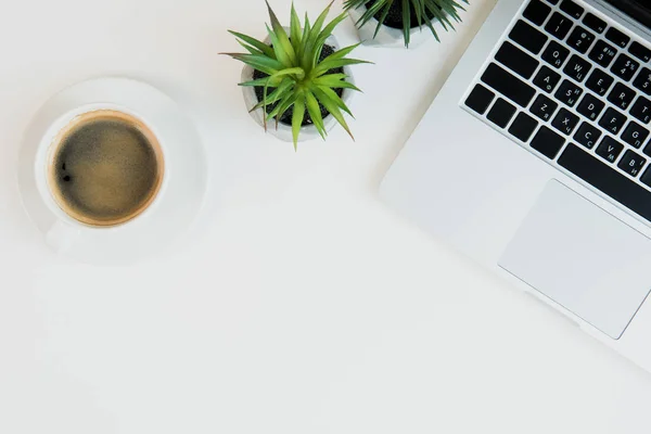 Laptop and cup of coffee — Stock Photo