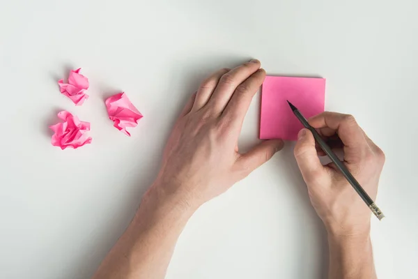 Hands holding pencil and sticker — Stock Photo