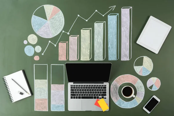 Portátil y gráficos de negocios - foto de stock