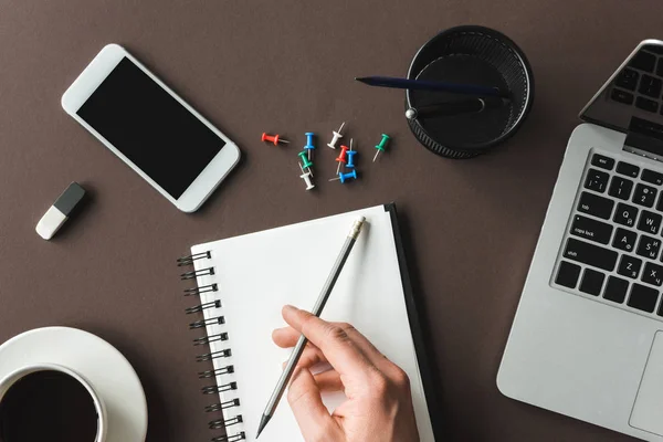 Person writing in notebook — Stock Photo