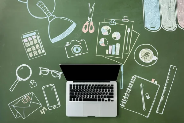 Laptop computer and pictures on board — Stock Photo