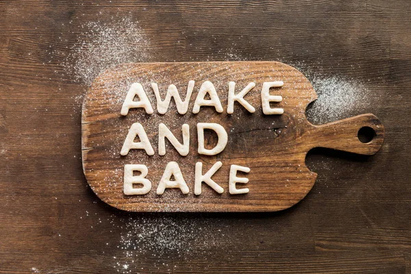 Edible lettering on cutting board — Stock Photo