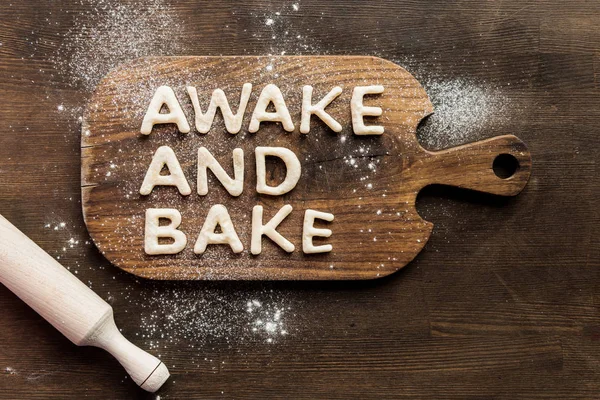 Edible lettering on cutting board — Stock Photo