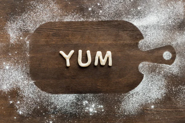 Edible lettering on cutting board — Stock Photo