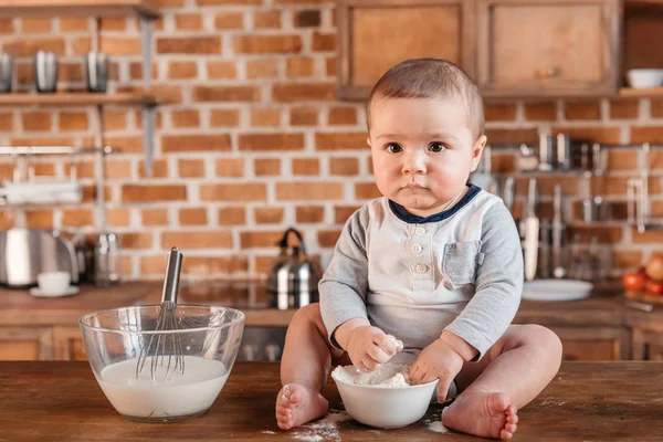 Little boy playing with flour — Stock Photo