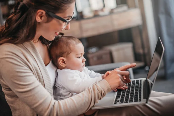 Mother with her son using laptop — Stock Photo
